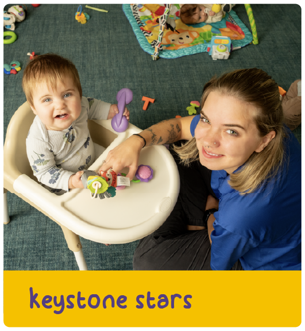 Caregiver and baby at a high chair with text 'keystone stars'