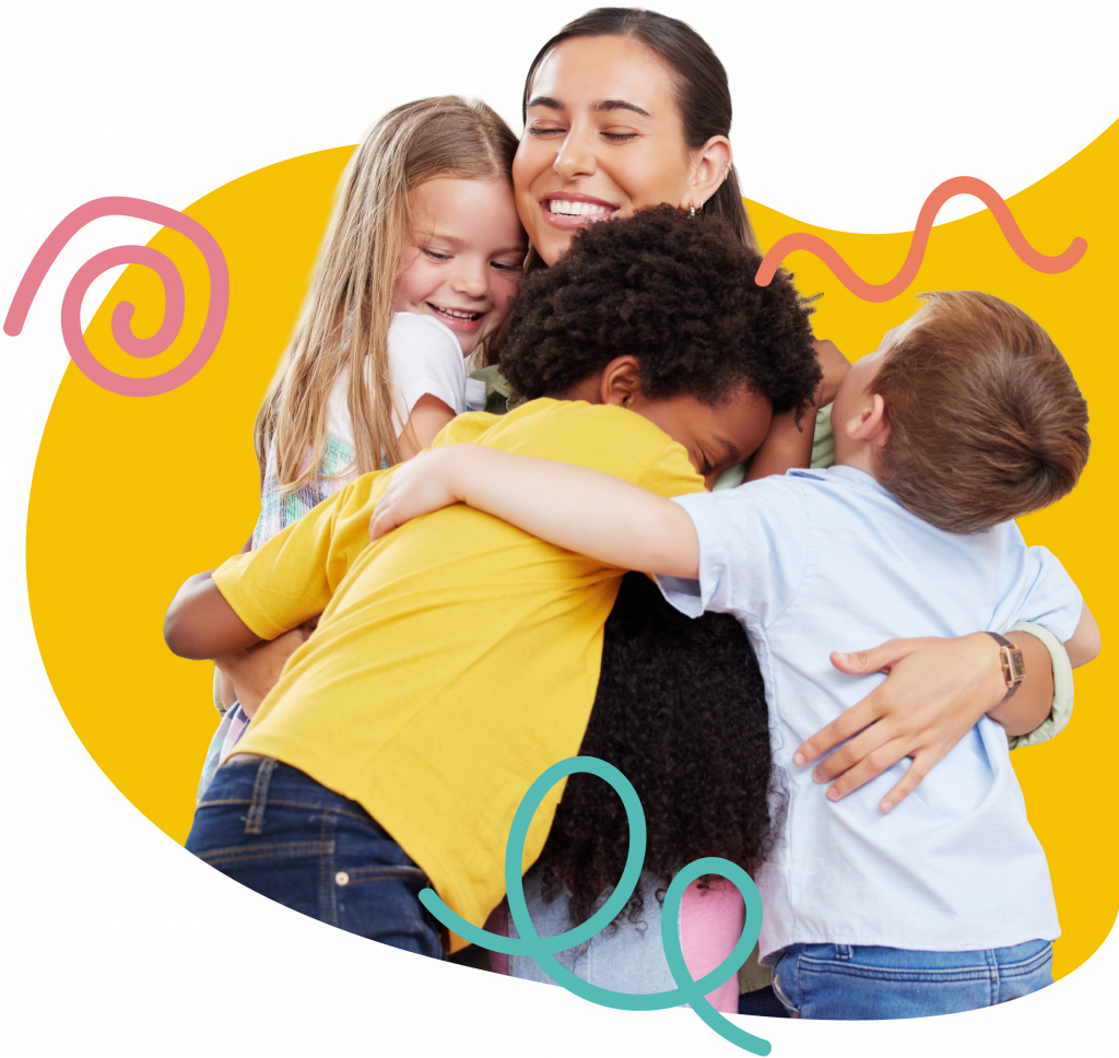 Teacher hugging a group of smiling children