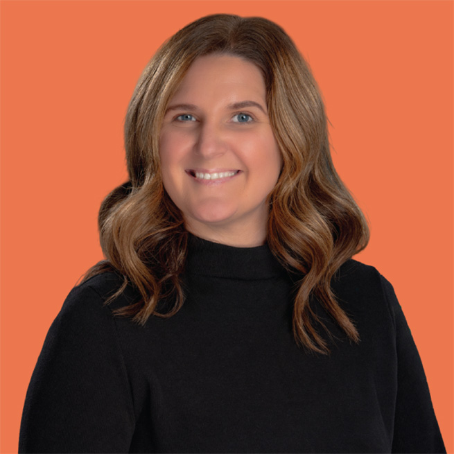 A Lifespan Childcare staff member with long light brown hair wearing a black turtleneck, smiling against an orange background